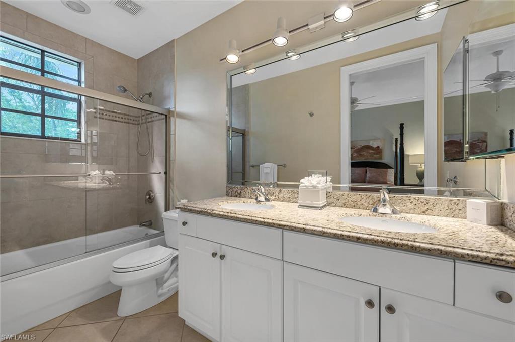 705 10th Street South, Unit 202 Naples, FL 34102 - Photo 11 of 17 a bathroom with a granite countertop sink toilet and shower
