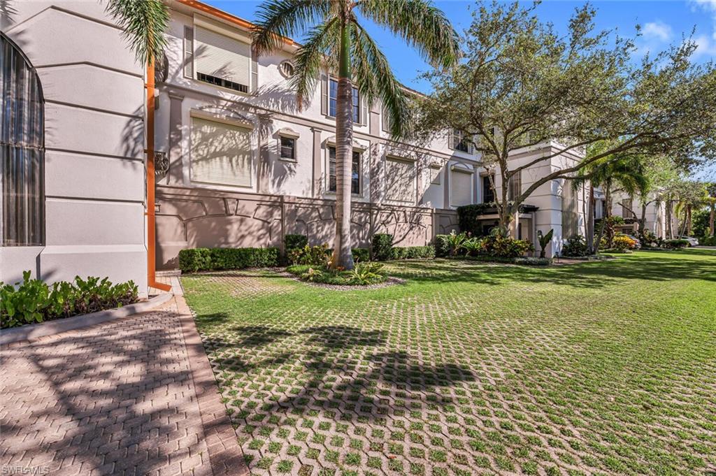 705 10th Street South, Unit 202 Naples, FL 34102 - Photo 12 of 17 a view of a building with a yard