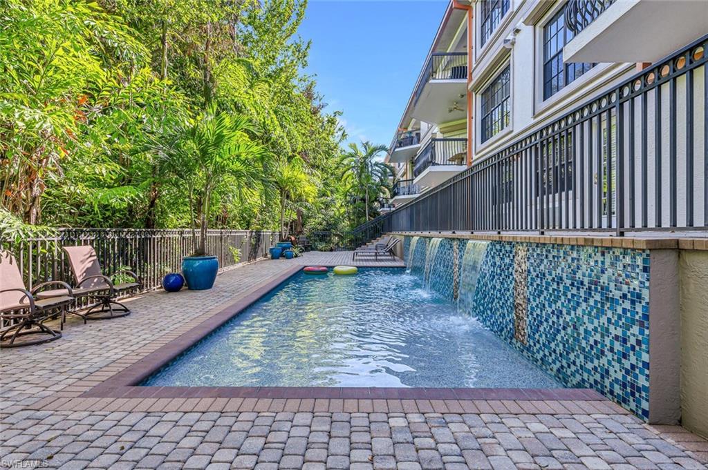 705 10th Street South, Unit 202 Naples, FL 34102 - Photo 15 of 17 a view of a roof deck with wooden fence and a bench