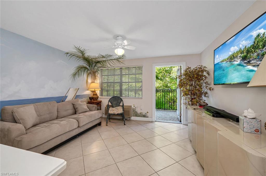 705 10th Street South, Unit 202 Naples, FL 34102 - Photo 16 of 17 a living room with furniture and a large window