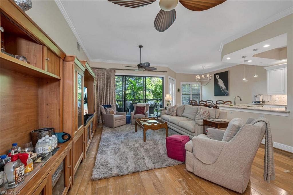 705 10th Street South, Unit 202 Naples, FL 34102 - Photo 2 of 17 a living room with furniture and a large window