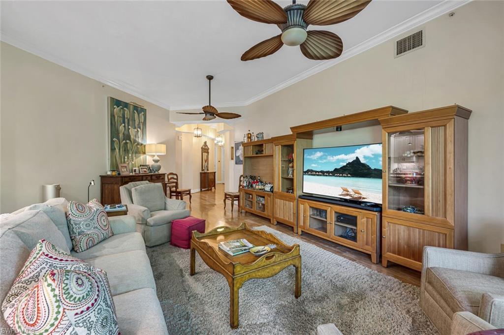 705 10th Street South, Unit 202 Naples, FL 34102 - Photo 3 of 17 a living room with furniture and a flat screen tv