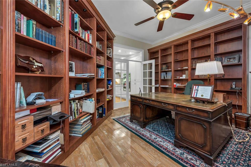 705 10th Street South, Unit 202 Naples, FL 34102 - Photo 5 of 17 a room with furniture and a book shelf