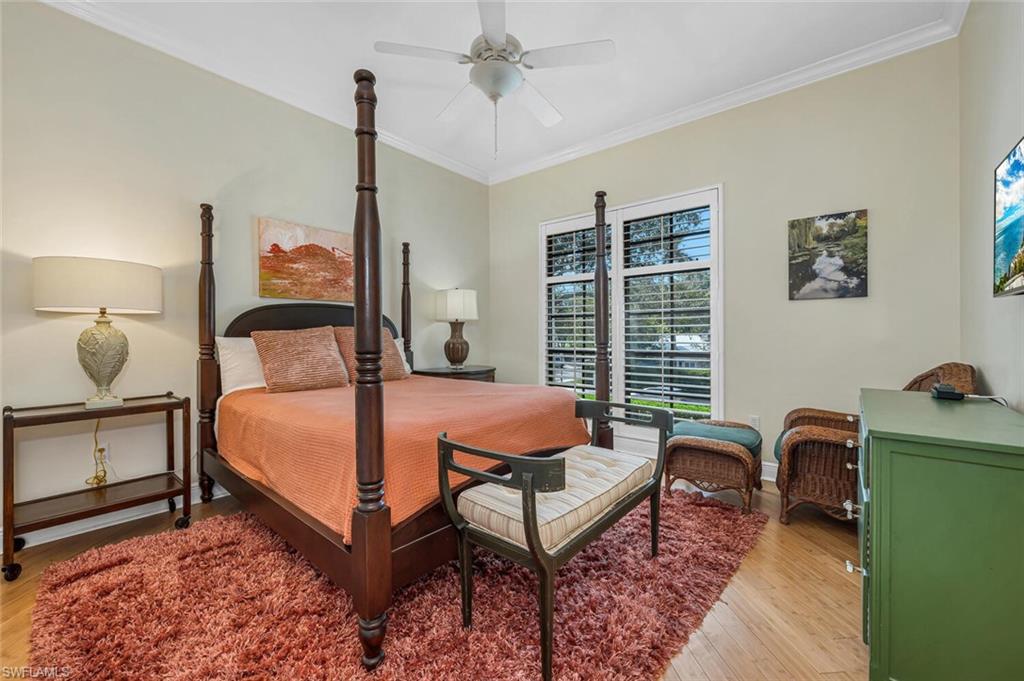 705 10th Street South, Unit 202 Naples, FL 34102 - Photo 6 of 17 a bedroom with a bed chair and window
