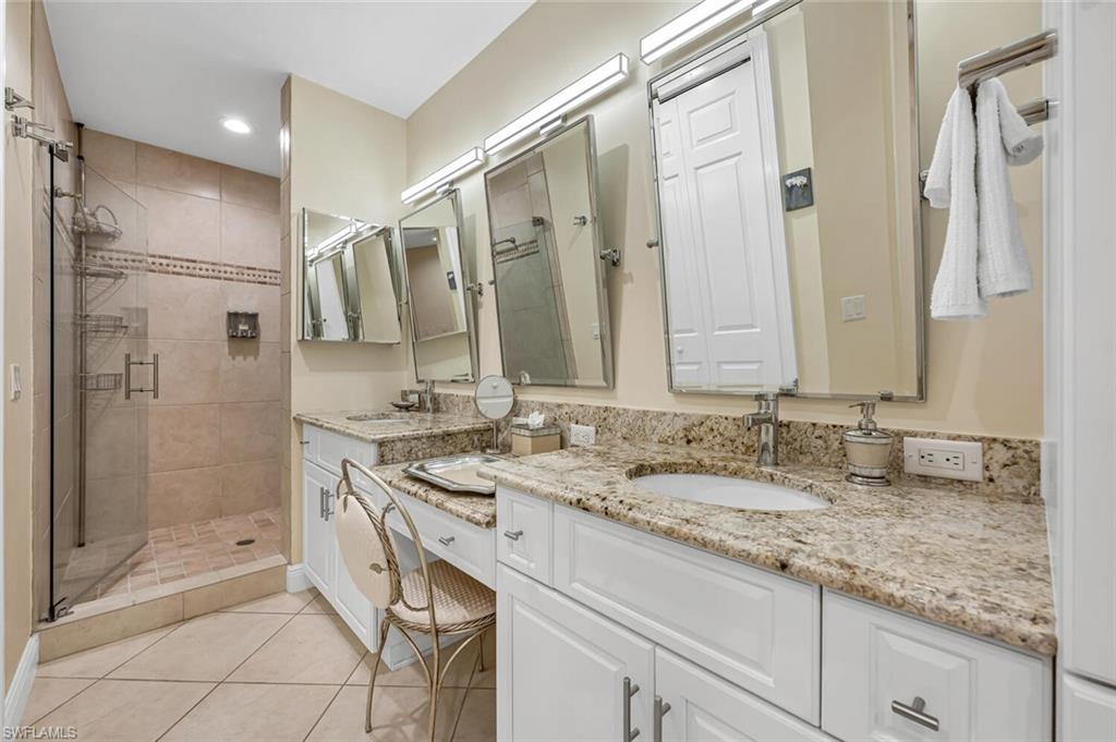 705 10th Street South, Unit 202 Naples, FL 34102 - Photo 7 of 17 a bathroom with a granite countertop double vanity sink mirror and shower