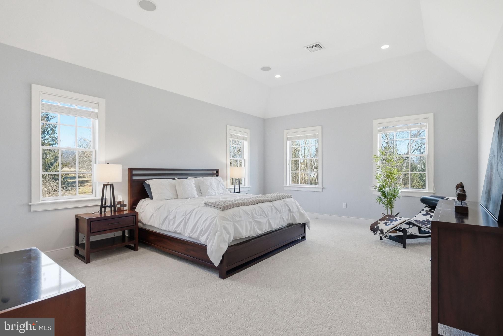 904 Plymouth Road Lower Gwynedd, PA 19002 - Photo 22 of 44 a spacious bedroom with a bed and wooden floor