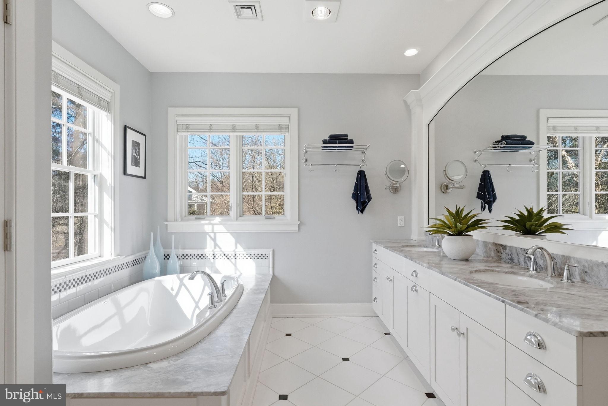 904 Plymouth Road Lower Gwynedd, PA 19002 - Photo 23 of 44 a spacious bathroom with a granite countertop double vanity sink a mirror and a bathtub