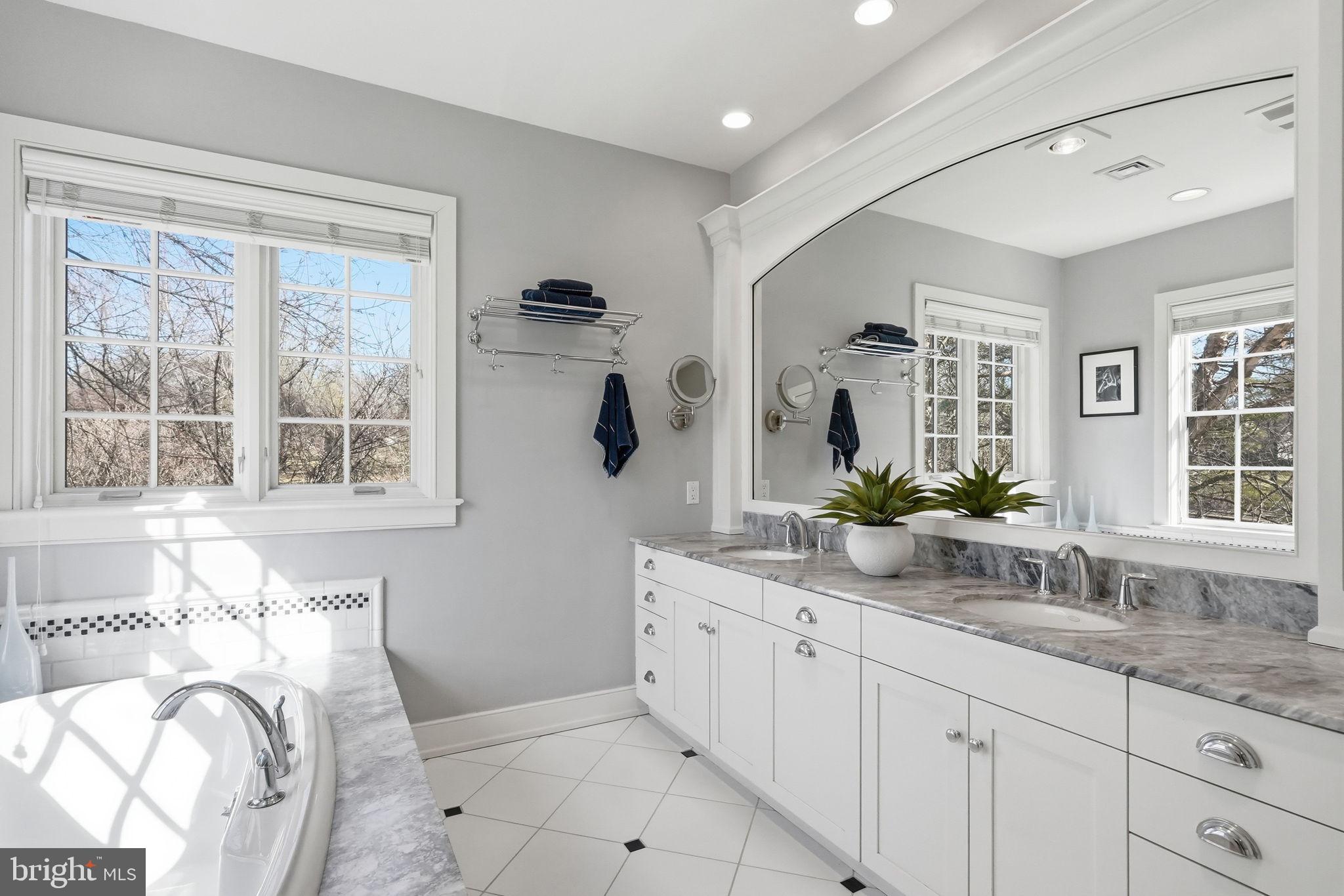 904 Plymouth Road Lower Gwynedd, PA 19002 - Photo 24 of 44 a spacious bathroom with sinks mirror and a bathtub