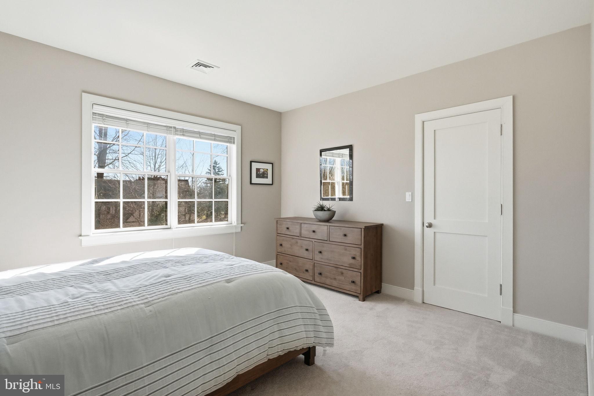 904 Plymouth Road Lower Gwynedd, PA 19002 - Photo 29 of 44 a spacious bedroom with a bed and a window
