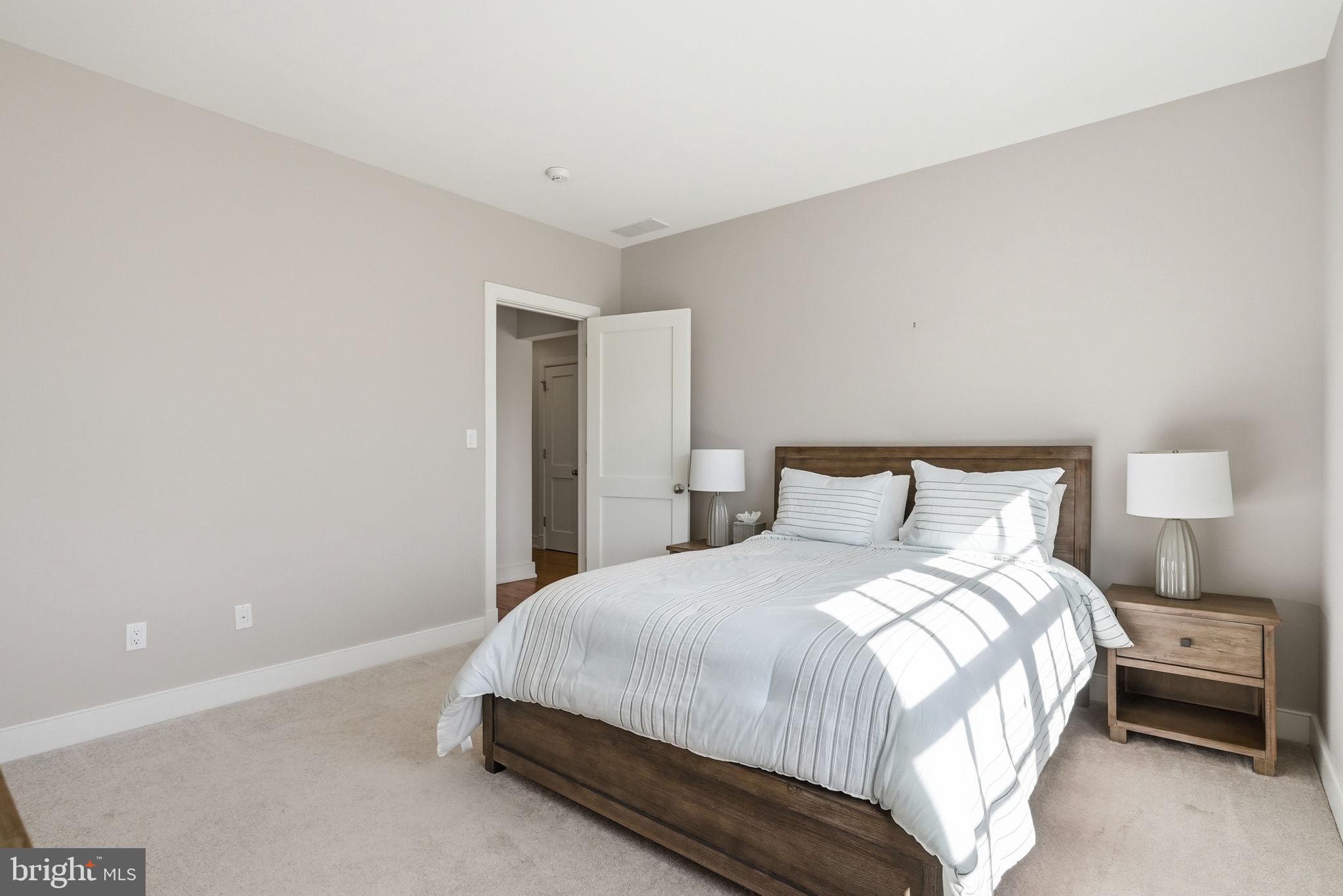 904 Plymouth Road Lower Gwynedd, PA 19002 - Photo 30 of 44 a bedroom with a bed and a lamp