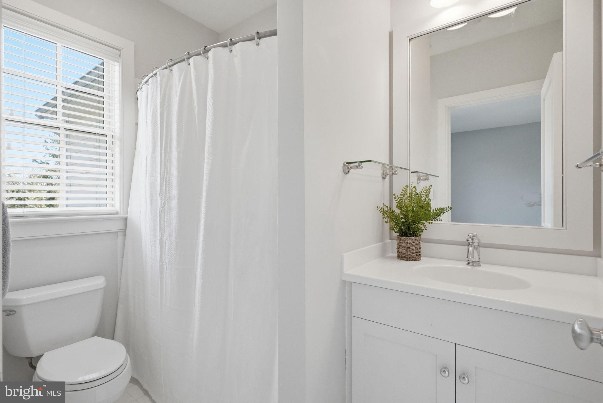 904 Plymouth Road Lower Gwynedd, PA 19002 - Photo 32 of 44 a bathroom with a sink a toilet and mirror