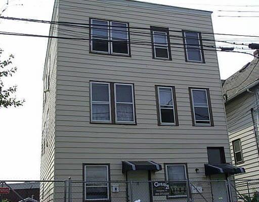 a view of a house with wooden deck