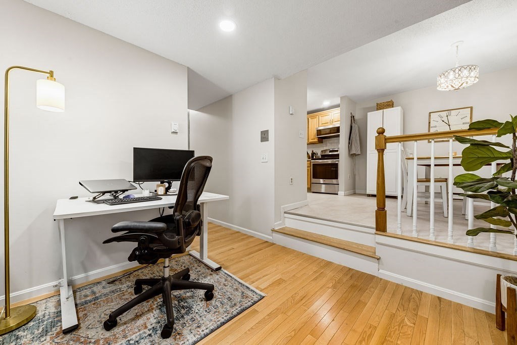 10 Erick Road, Unit 42 Mansfield, MA 02048 - Photo 9 of 33 a view of a workspace with furniture and wooden floor