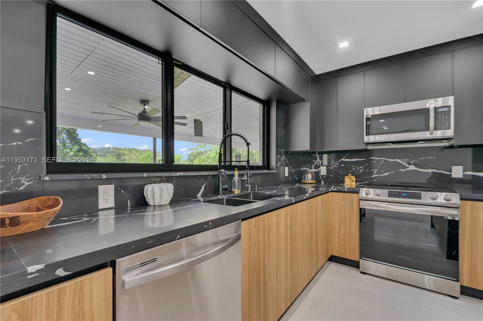 17680 Southwest 54th Street Southwest Ranches, FL 33331 - Photo 11 of 40 a kitchen with stainless steel appliances a sink stove and cabinets