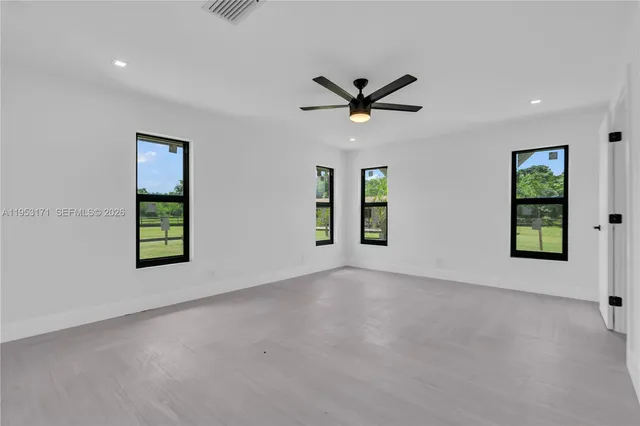 an empty room with windows and closet
