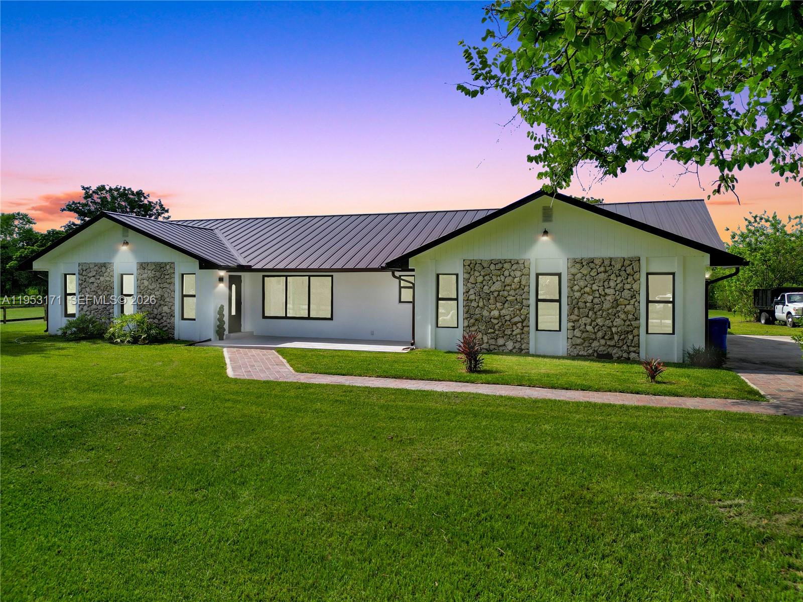17680 Southwest 54th Street Southwest Ranches, FL 33331 - Photo 2 of 40 a front view of a house with a yard