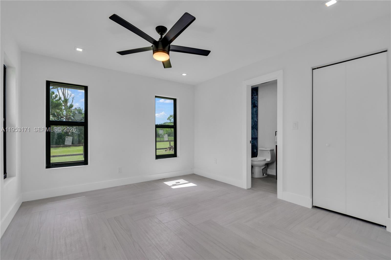 17680 Southwest 54th Street Southwest Ranches, FL 33331 - Photo 21 of 40 a view of a livingroom with a ceiling fan & windows