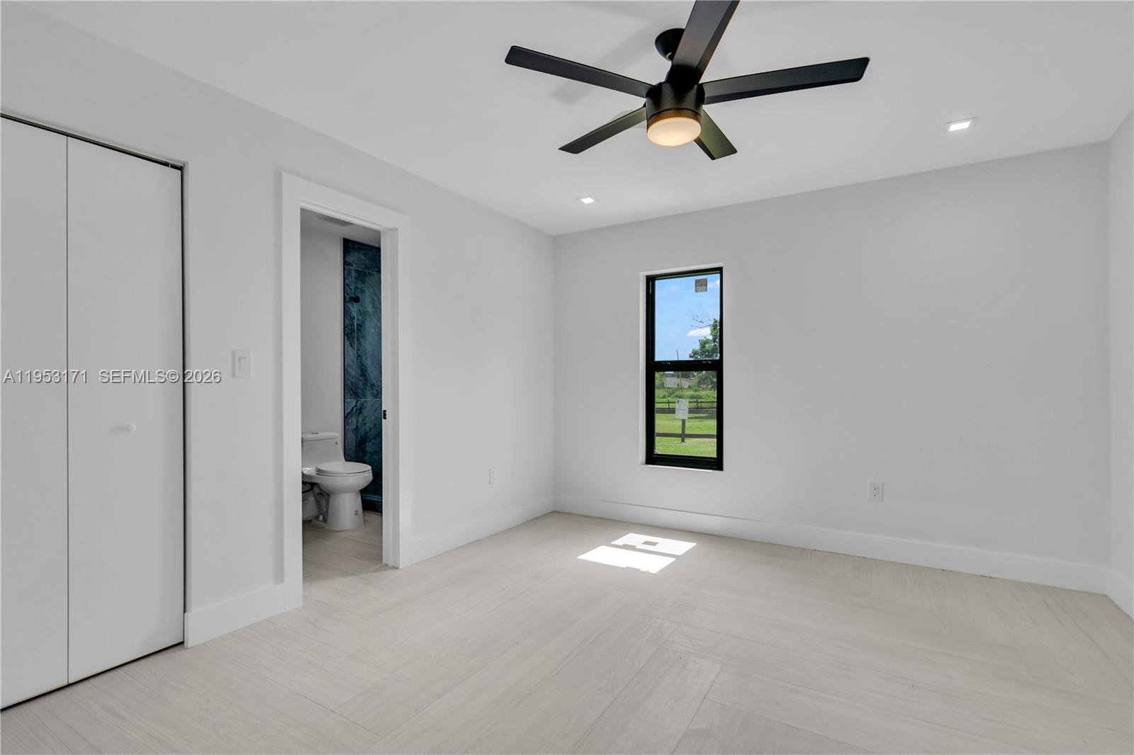 17680 Southwest 54th Street Southwest Ranches, FL 33331 - Photo 24 of 40 an empty room with windows and a ceiling fan
