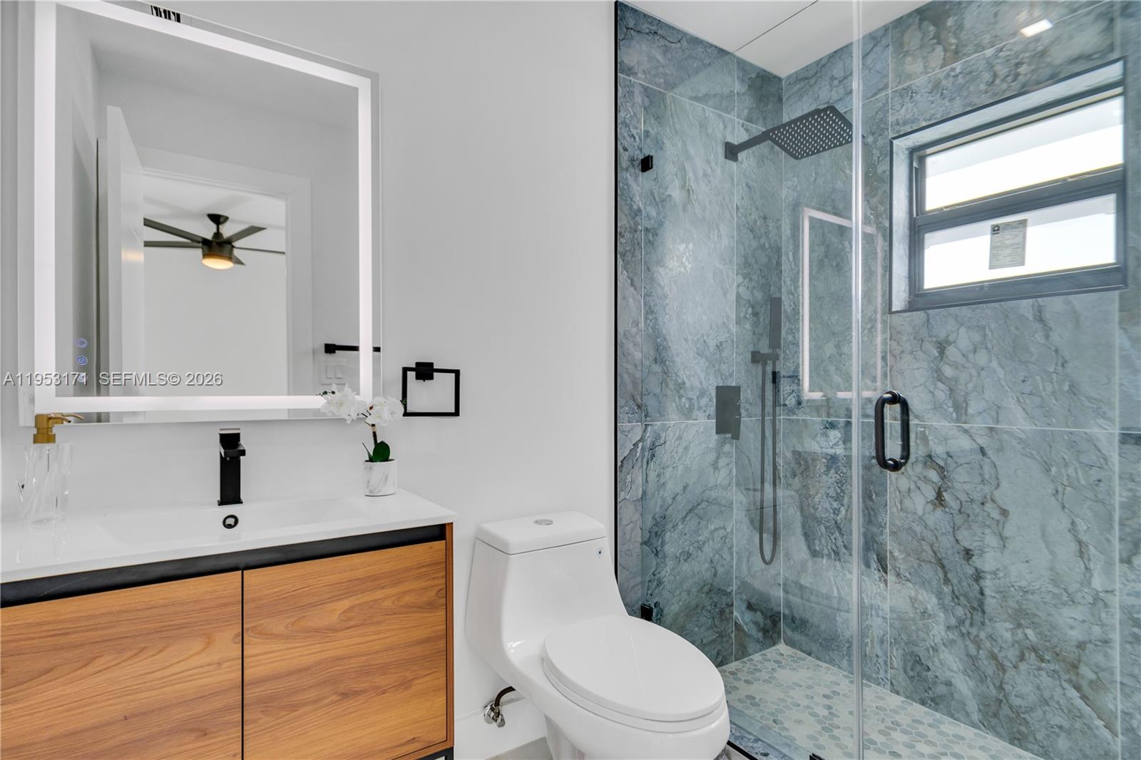 17680 Southwest 54th Street Southwest Ranches, FL 33331 - Photo 25 of 40 a bathroom with a sink toilet and shower