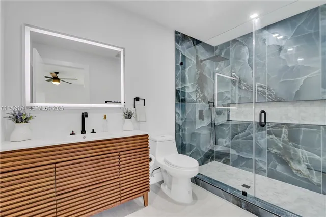 a bathroom with a sink a toilet and mirror