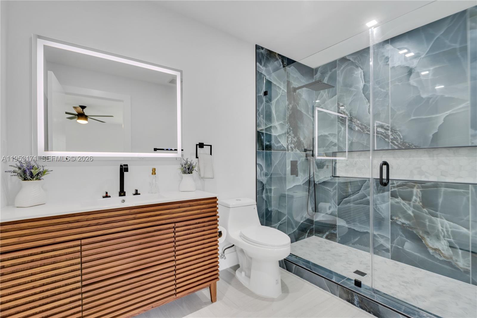 17680 Southwest 54th Street Southwest Ranches, FL 33331 - Photo 27 of 40 a bathroom with a sink a toilet and shower