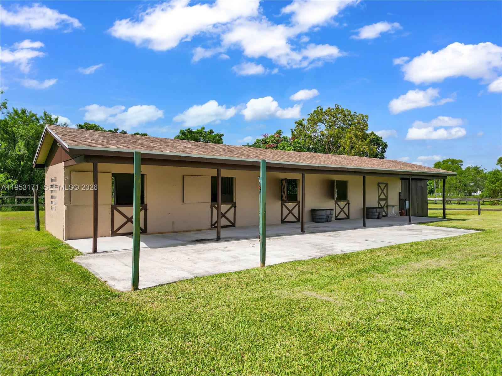 17680 Southwest 54th Street Southwest Ranches, FL 33331 - Photo 33 of 40 a view of a house with a yard and a patio