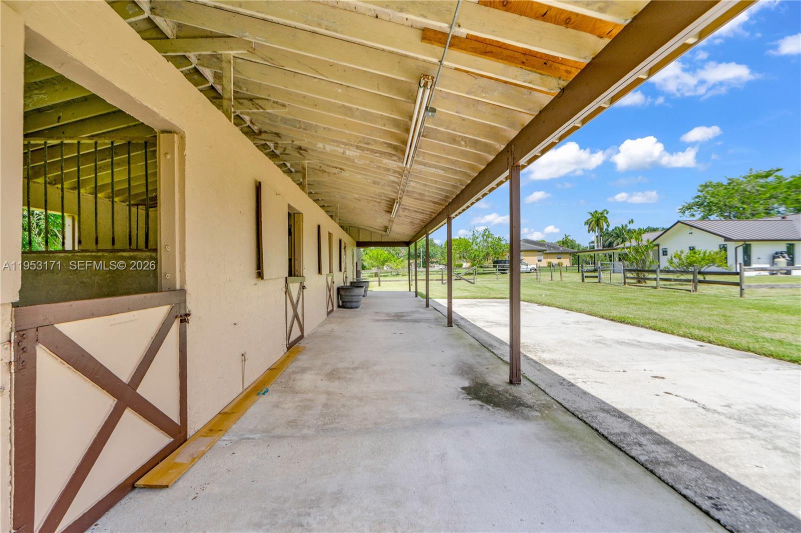 17680 Southwest 54th Street Southwest Ranches, FL 33331 - Photo 34 of 40 a view of a porch with furniture and a yard