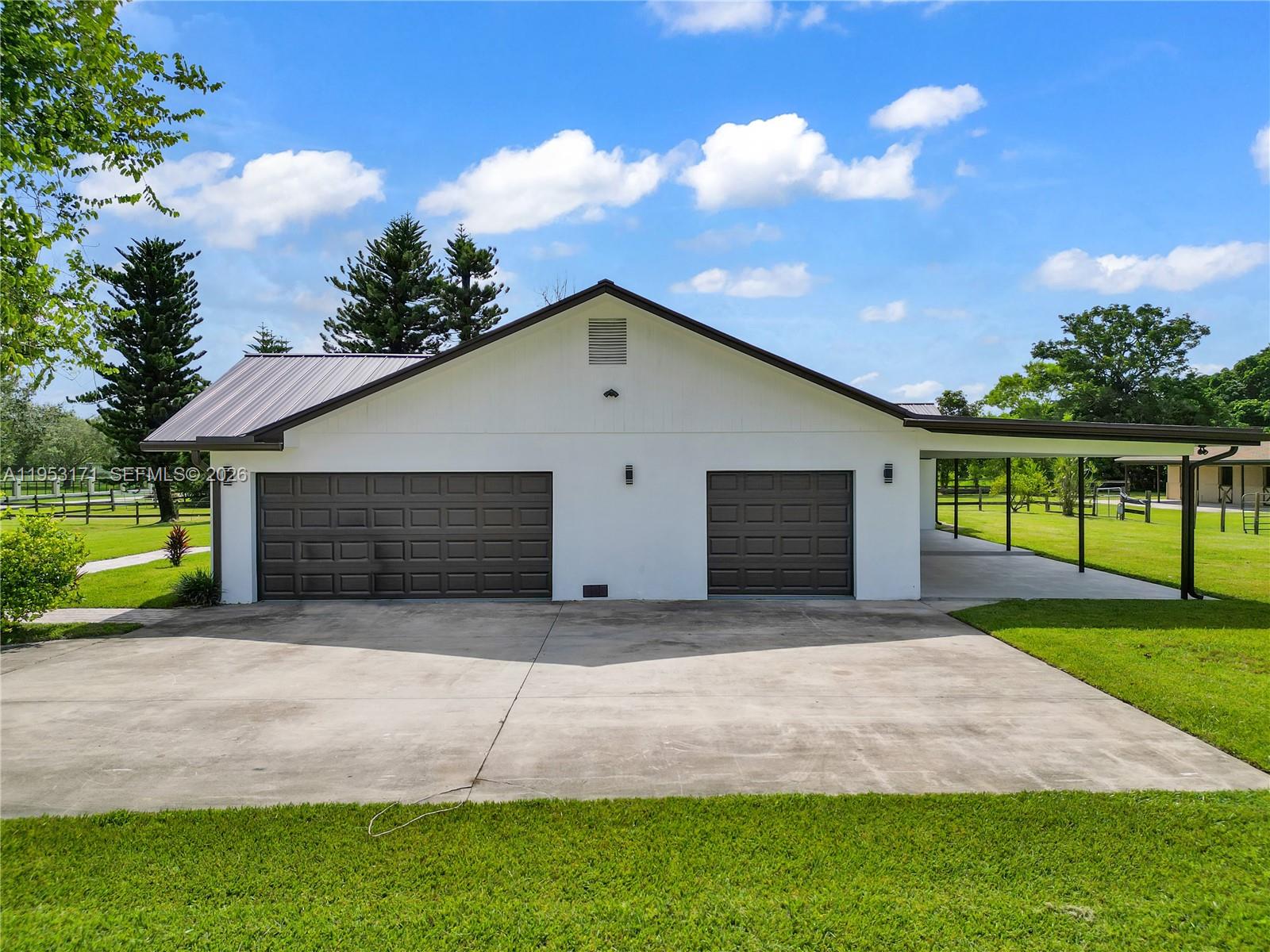 17680 Southwest 54th Street Southwest Ranches, FL 33331 - Photo 37 of 40 a front view of a house with a yard and garage