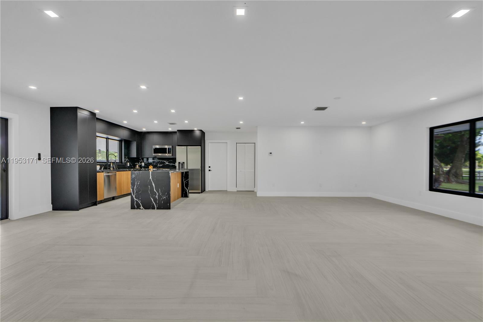 17680 Southwest 54th Street Southwest Ranches, FL 33331 - Photo 8 of 40 a view of an empty room with furniture and kitchen area