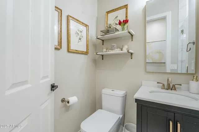 a bathroom with a toilet a sink and mirror