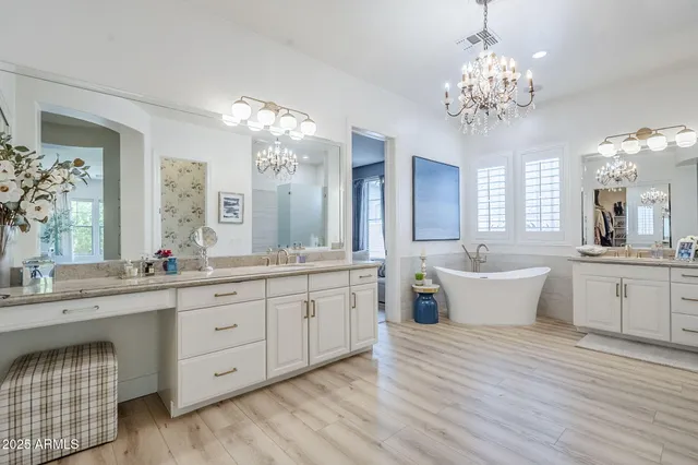 a large bathroom with a double vanity sink large mirror and a bathtub