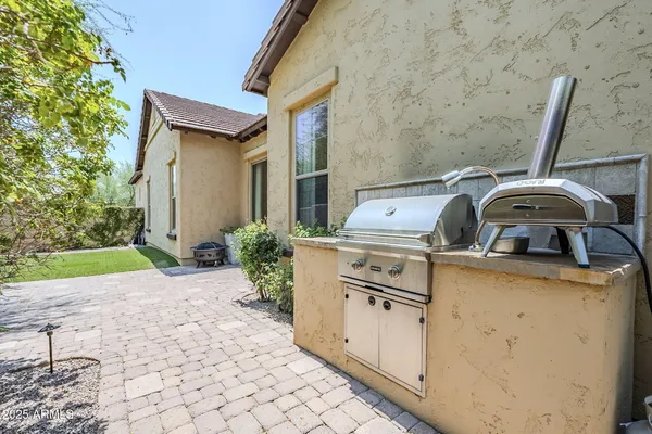 a view of barbeque grill with granite counter top