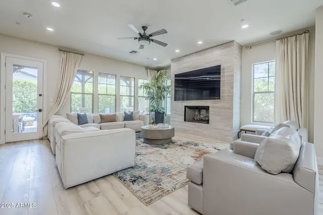 a living room with furniture a flat screen tv and a fireplace
