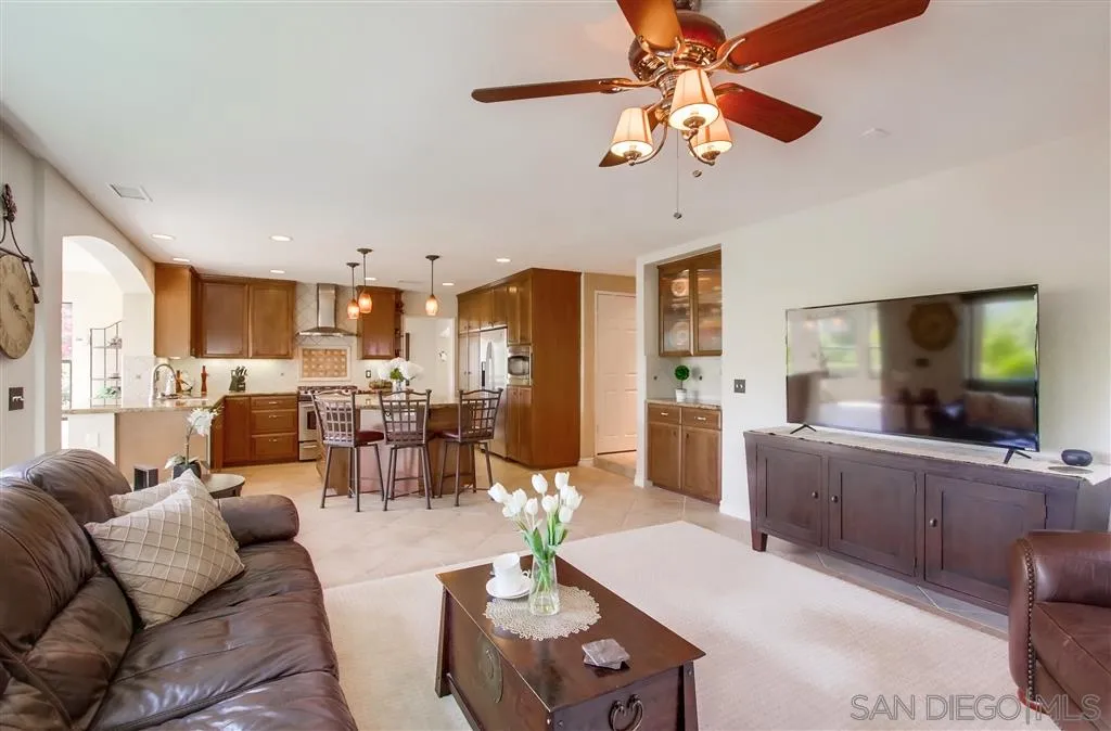 14032 Old Station Road Poway, CA 92064 - Photo 12 of 25 a living room with furniture kitchen view and a large window