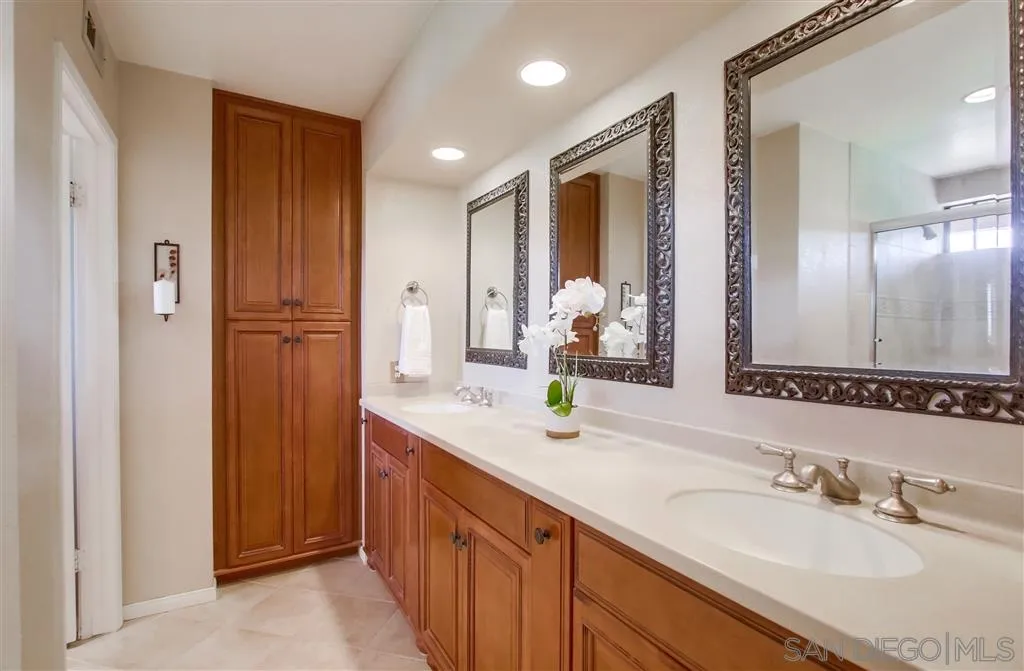 14032 Old Station Road Poway, CA 92064 - Photo 14 of 25 a bathroom with a sink double vanity and a mirror