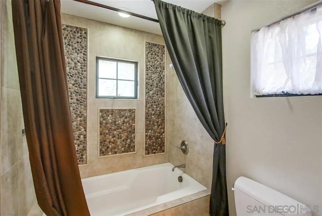 14032 Old Station Road Poway, CA 92064 - Photo 18 of 25 a bathroom with a bathtub and a shower