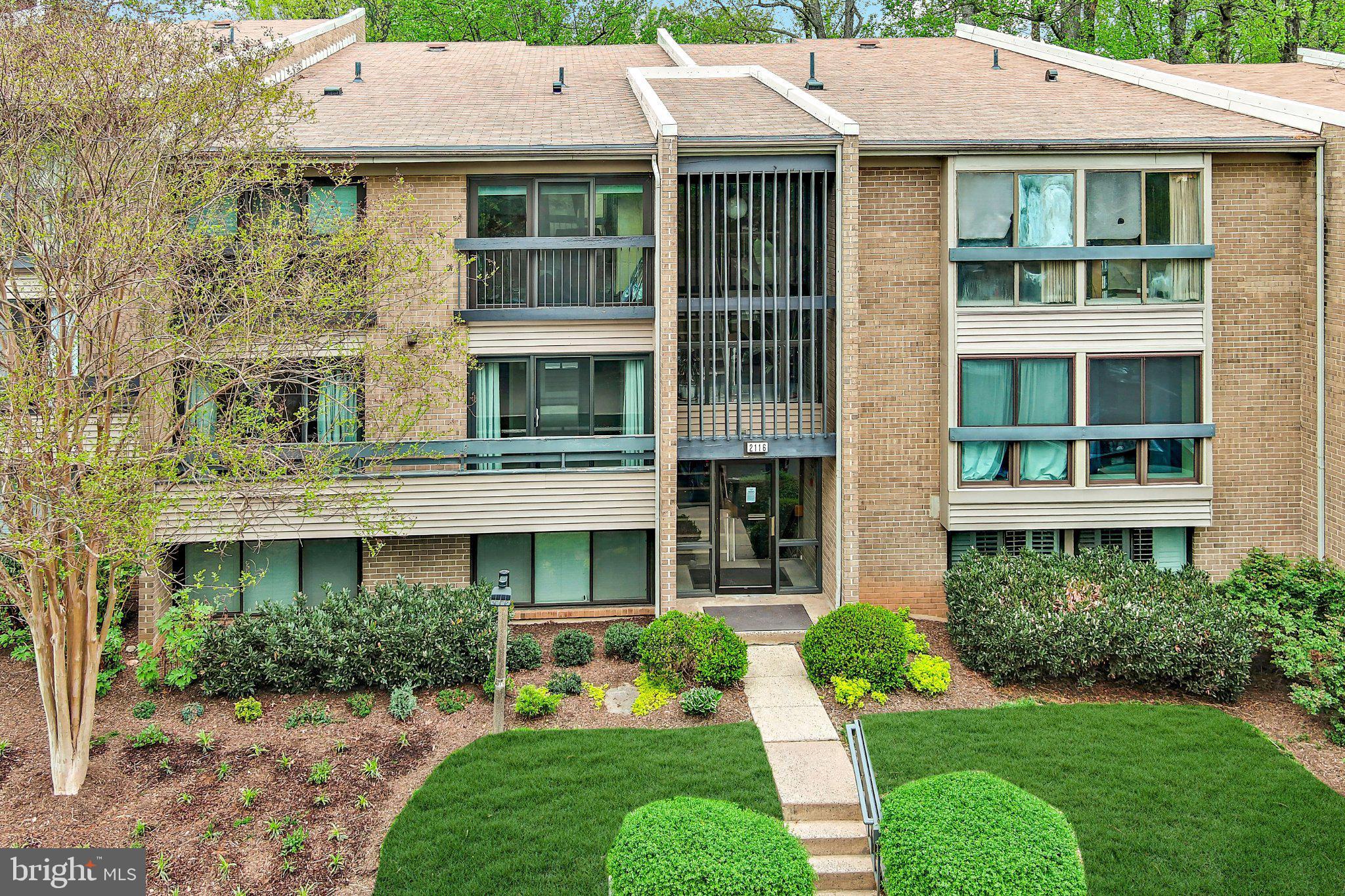 Charming brick facade with lush greenery.