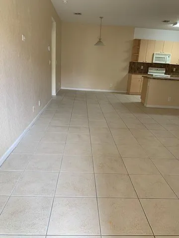 a view of a kitchen with a sink and cabinets