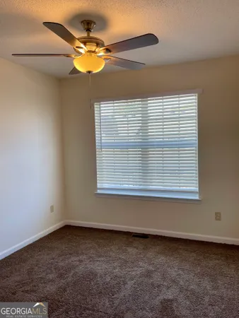 a view of a ceiling fan and a window