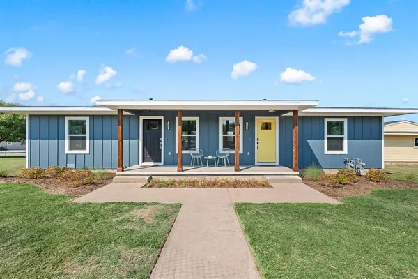 a front view of a house with a garden