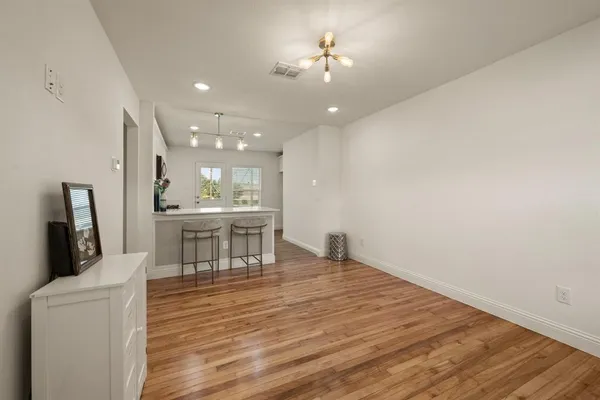 a view of a dining room with furniture and a chandelier