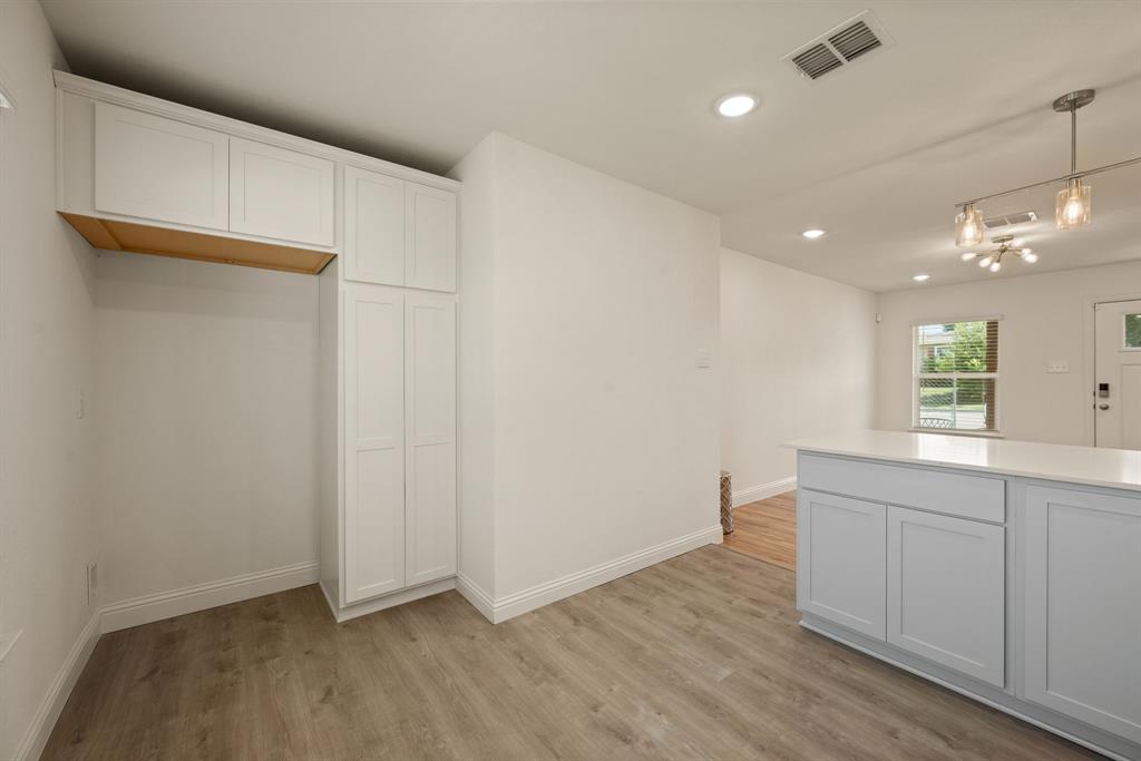 4096 Merida Avenue Fort Worth, TX 76110 - Photo 8 of 17 a view of an empty room with wooden floor and a window