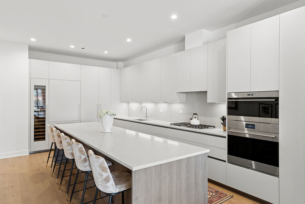 323 South Racine Avenue, Unit PHD Chicago, IL 60607 - Photo 2 of 47 a kitchen with stainless steel appliances a stove a sink a microwave and cabinets