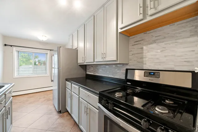 a kitchen with a stove and a refrigerator