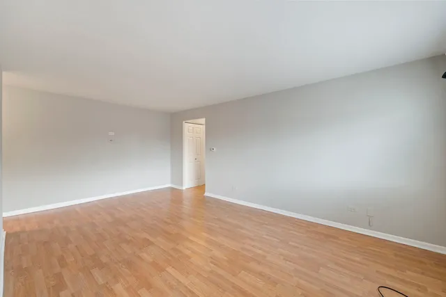 a view of an empty room and wooden floor