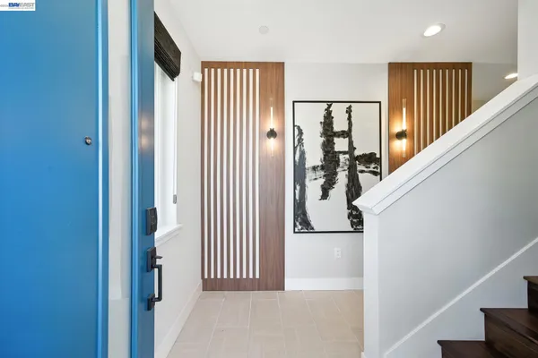 a view of a hallway with wooden floor and stairs