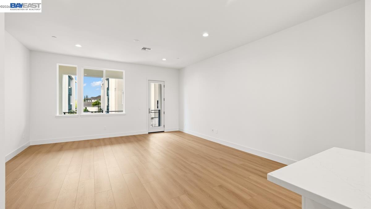 1925 Grand Street Alameda, CA 94501 - Photo 16 of 39 an empty room with wooden floor and windows