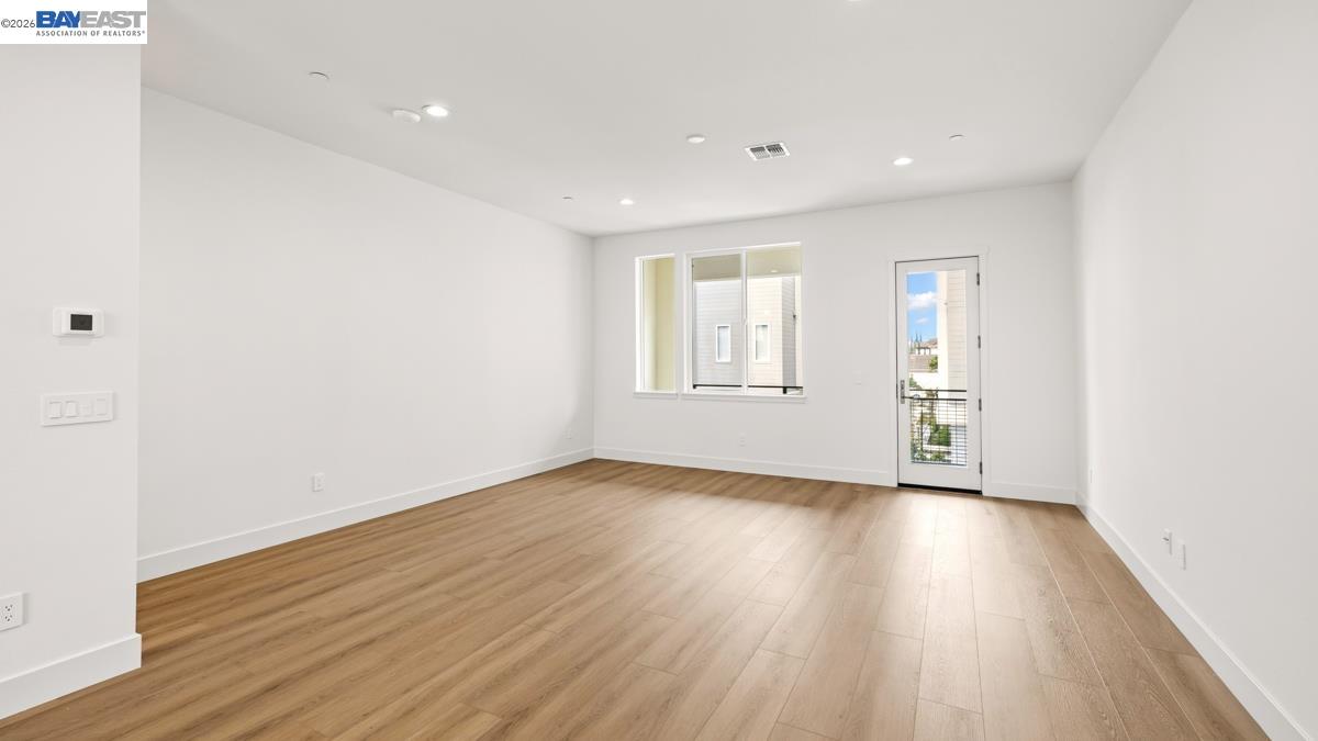 1925 Grand Street Alameda, CA 94501 - Photo 17 of 39 an empty room with wooden floor and windows