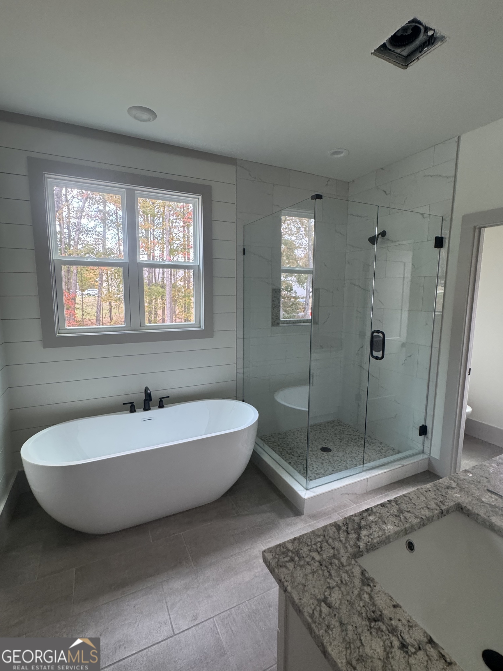 115 Cliffs Drive Dalton, GA 30721 - Photo 9 of 10 a spacious bathroom with a tub shower and window