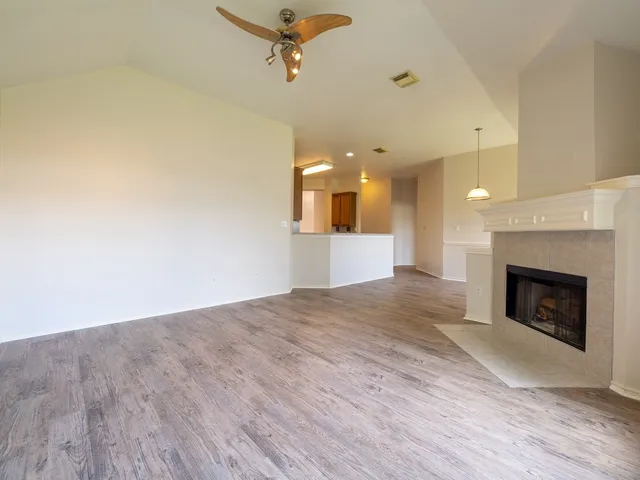 a view of a kitchen with a sink and a fireplace